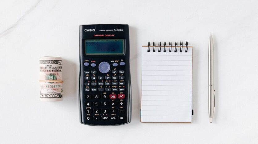 calculadora dolar y anotador con lapicera